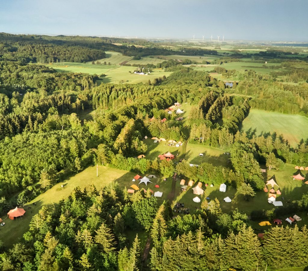 drone shot of large camping site in a forest